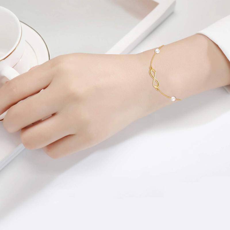 Pulsera con dije de símbolo de infinito, diamantes y perlas en oro blanco de 10 quilates-2