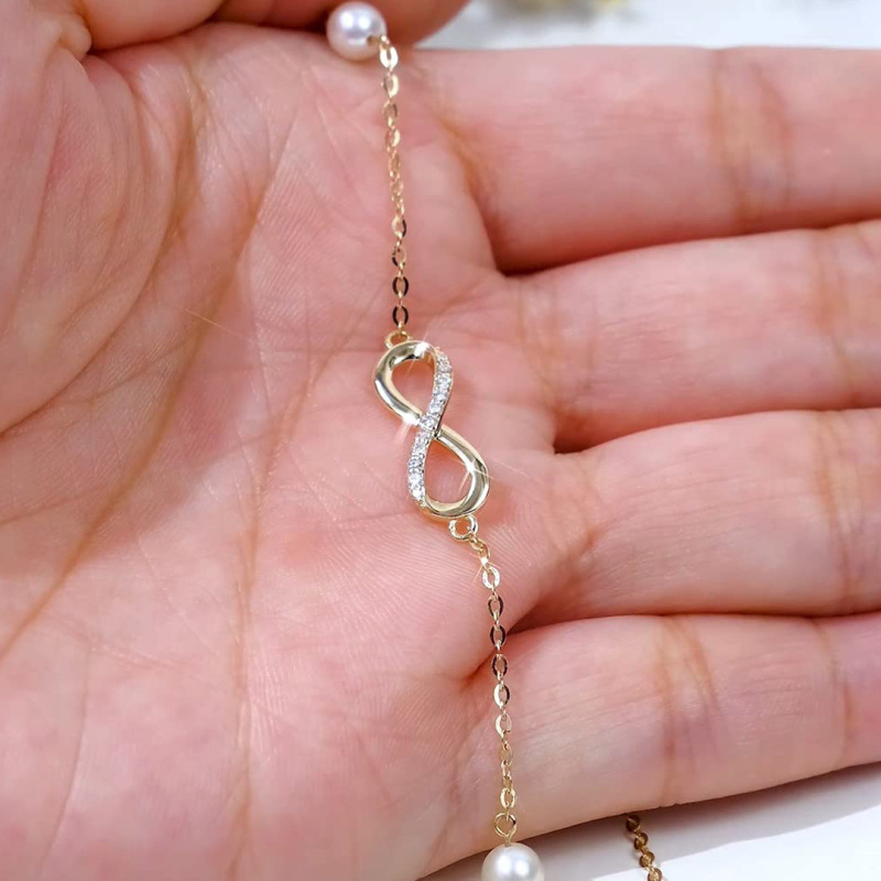 Pulsera con dije de símbolo de infinito, diamantes y perlas en oro blanco de 10 quilates-3