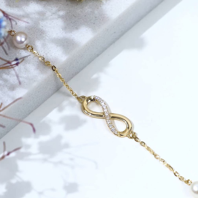 Pulsera con dije de símbolo de infinito, diamantes y perlas en oro blanco de 10 quilates-4