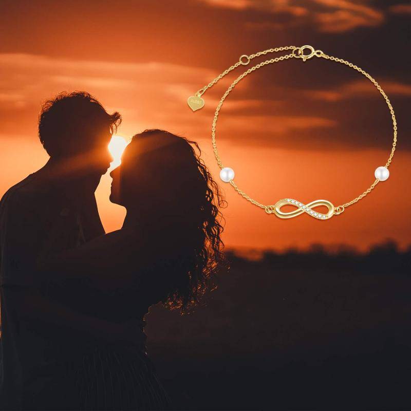 Pulsera con dije de símbolo de infinito, diamantes y perlas en oro blanco de 10 quilates-5