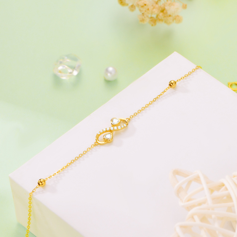 Pulsera con dije de símbolo de infinito en oro de 10 quilates y circonitas cúbicas-4