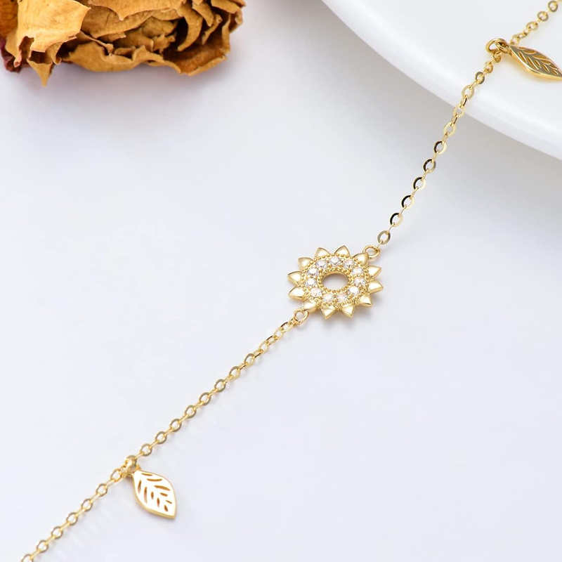 Bransoletka z zawieszkami z cyrkonii sześciennej i słonecznika wykonana ze złota próby 10K-4