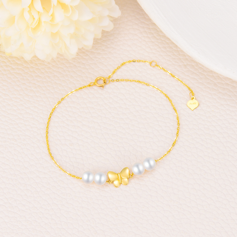 Pulsera con dije de mariposa y perla en oro de 14 quilates-4