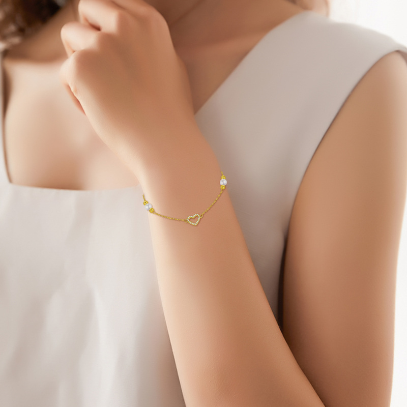 Pulseira com pendente coração em ouro branco 10K, zircónias cúbicas e pérola.-2