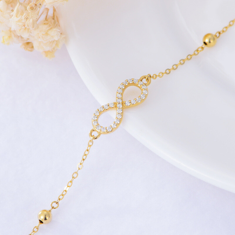 Tornozeleira com pendente de camada única em ouro 14K com zircónia cúbica e símbolo do infinito-4