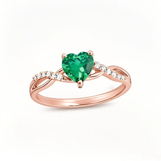 Anillo de compromiso de oro rosa de 10 quilates con esmeralda de corte corazón y 0,05 quilates de peso total en diamantes redondos con cuerpo retorcido.
