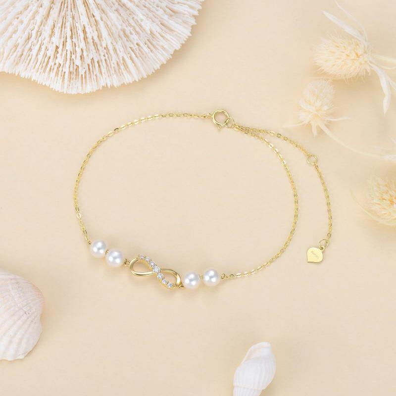 Pulsera con dije de símbolo infinito de perla y diamantes en oro de 18 quilates-3