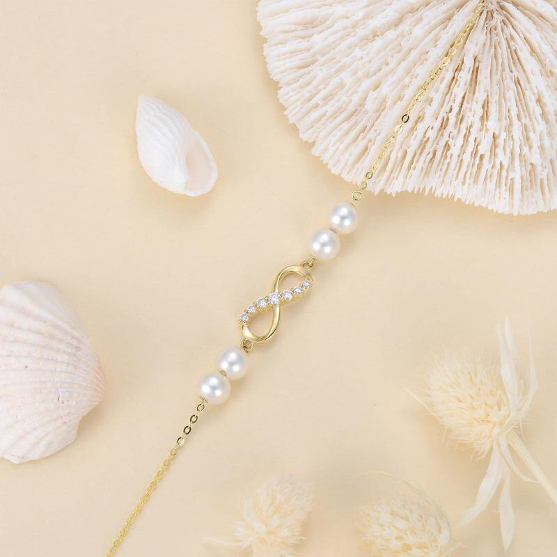 Pulsera con dije de símbolo infinito de perla y diamantes en oro de 18 quilates-4