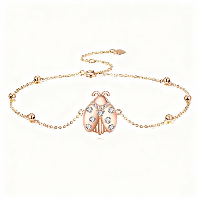 Pulsera con dije de mariquita de oro rosa de 14 quilates y circonitas cúbicas-1