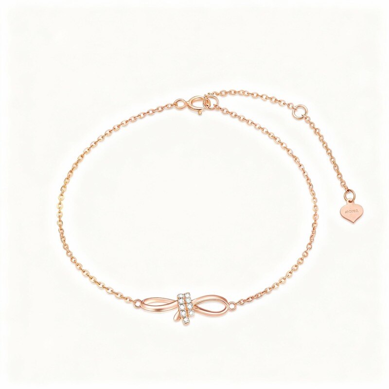 Bracelet en or rose 18 carats avec pendentif nœud et cœur orné de diamants-1