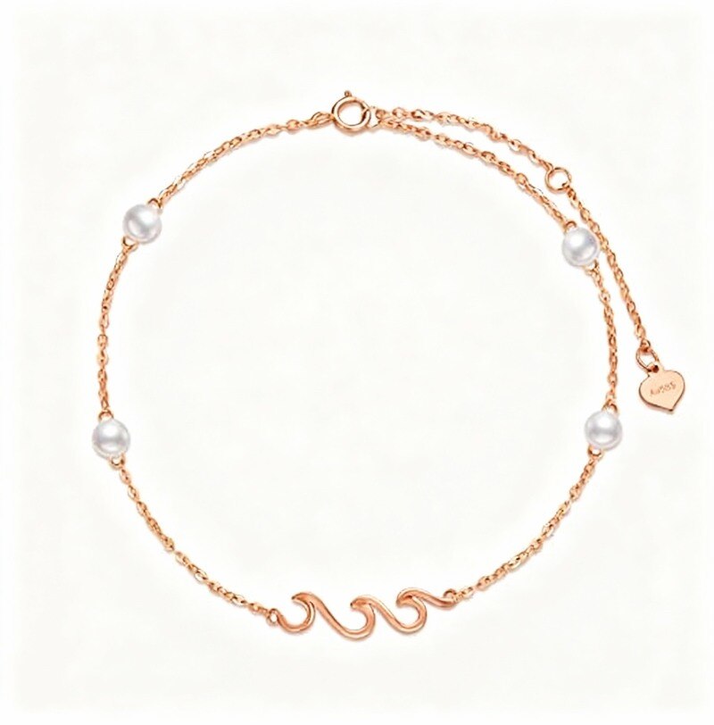 Bracelet à breloques en or rose 14 carats et perles.-1