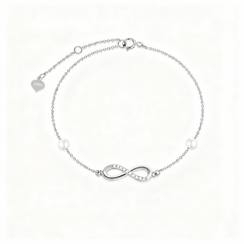 Pulsera con dije de símbolo de infinito, diamantes y perlas en oro blanco de 10 quilates-1