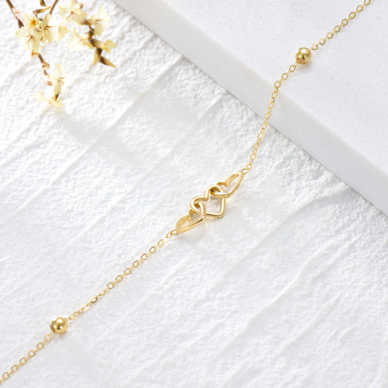 Pulseira de senhora em ouro amarelo 9K com pendente de coração e contas em forma de coração.-5