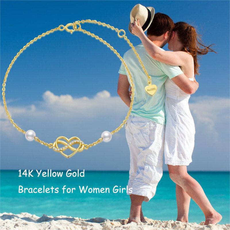 Pulseira de senhora em ouro 14K com pérola, pendente de coração e símbolo do infinito em zircónia cúbica.-5
