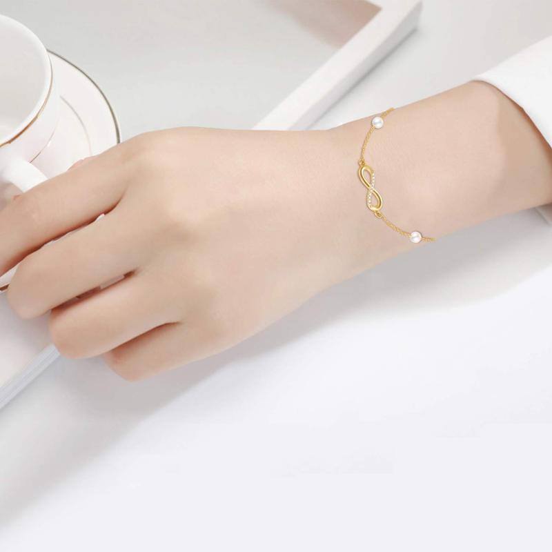 Pulsera con dije de símbolo infinito de oro de 14 quilates, diamantes y perlas-2